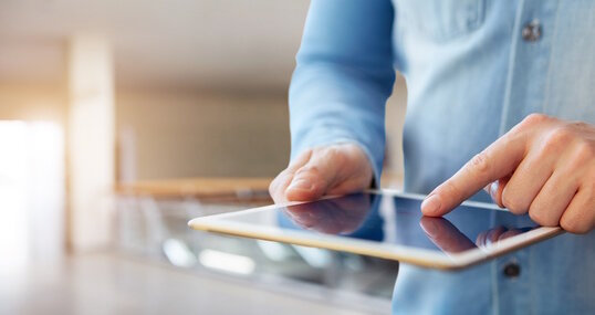 Male hand touching a digital tablet